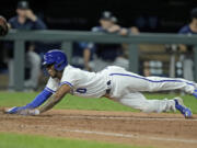 Kansas City Royals' Samad Taylor dives home to score the game-winning run on a bunt single by Dairon Blanco during the ninth inning of a baseball game Monday, Aug. 14, 2023, in Kansas City, Mo. The Royals won 7-6.