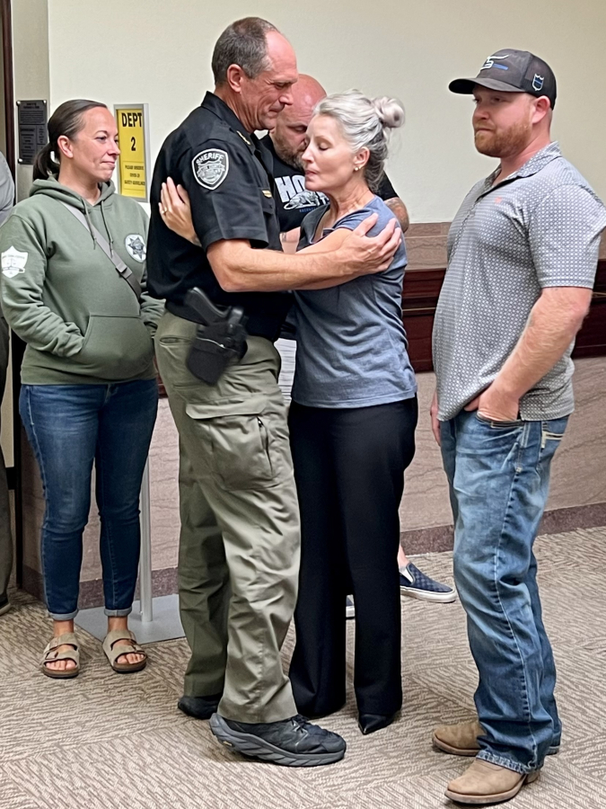 Clark County Sheriff John Horch and Jill Brown, widow of slain sheriff's Sgt. Jeremy Brown, embrace outside the courtroom Thursday after the guilty verdicts are read in Abran Raya Leon's felony murder trial in Clark County Superior Court.