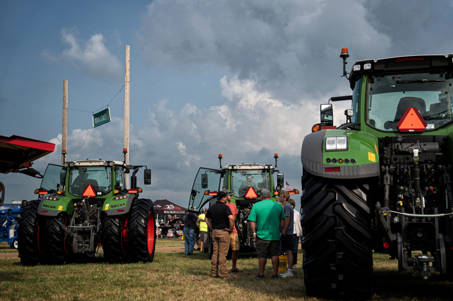 People look over the latest in heavy farm equipment Aug. 2 at Ziegler Ag at Farmfest in Morgan, Minn.