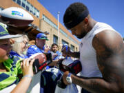 Seattle Seahawks safety Jamal Adams signs autographs for fans after practice at the NFL football team's training camp Thursday, Aug. 3, 2023, in Renton, Wash.