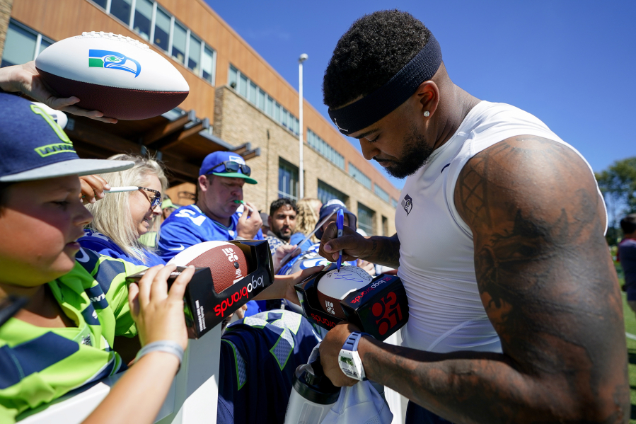 Seattle Seahawks safety Jamal Adams signs autographs for fans after practice at the NFL football team's training camp Thursday, Aug. 3, 2023, in Renton, Wash.