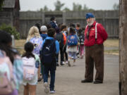 Volunteer Mike Riley welcomes students from Vancouver Innovation, Technology and Arts Elementary School to Fort Vancouver National Historic Site on Sept. 13, 2022.