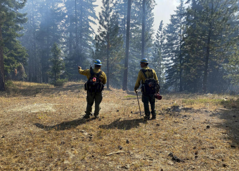 Two firefighters discuss firefighting options in the North Fork Nile Creek area.
