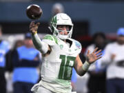 FILE -Oregon quarterback Bo Nix throws a pass during the second half of the team's Holiday Bowl NCAA college football game against North Carolina on Wednesday, Dec. 28, 2022, in San Diego. Bo Nix has settled in at Oregon, ready for a better outcome in his final year with the Ducks. The senior quarterback was getting Heisman buzz for a time last season before he got injured and the Ducks got derailed.