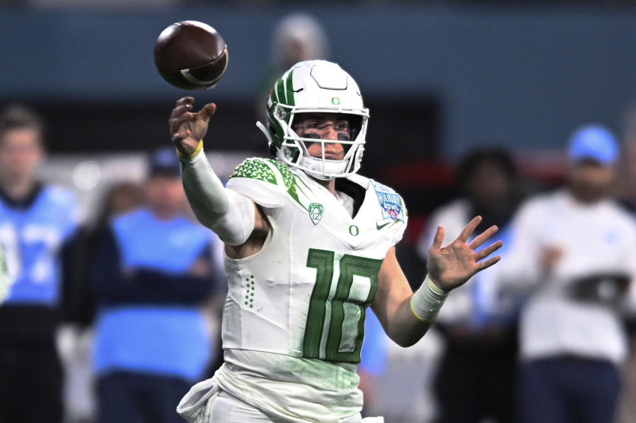 FILE -Oregon quarterback Bo Nix throws a pass during the second half of the team's Holiday Bowl NCAA college football game against North Carolina on Wednesday, Dec. 28, 2022, in San Diego. Bo Nix has settled in at Oregon, ready for a better outcome in his final year with the Ducks. The senior quarterback was getting Heisman buzz for a time last season before he got injured and the Ducks got derailed.
