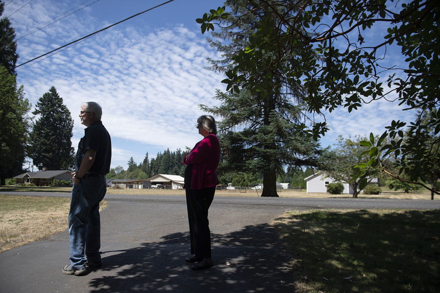 Perry Casper, left, joins his wife, Ellen, as they stand in the driveway in the Glenwood area where their daughter, Rachel, was killed by a negligent driver in 2020. A new law co-sponsored by Rep. Paul Harris, R-Vancouver, will increase the penalties for cases like Rachel Casper's. The new law will take effect Jan. 1, 2025.  At top, Perry Casper shares a photo from Rachel's graduation.