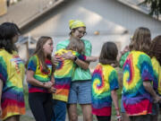 Campers Navaea Galang, 13, from left, and Lilee Foltz, 14, of Vancouver join counselor Kayla Laird, yellow scarf, as she shares a hug with camper Kaitlin Gregersen, 13, of Washougal at Merry Heart Children's Camp.