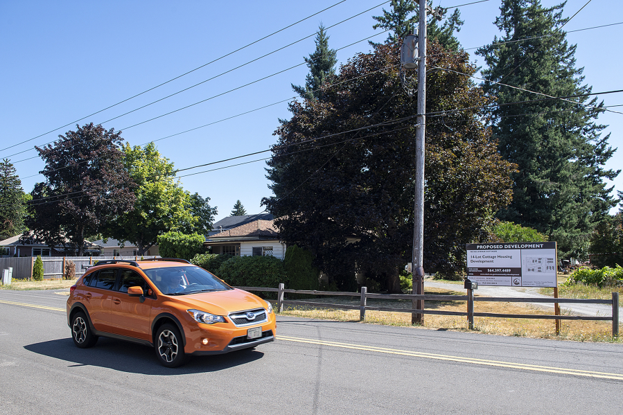 A motorist passes by the site of future cottage cluster developments along Northeast 58th Avenue.