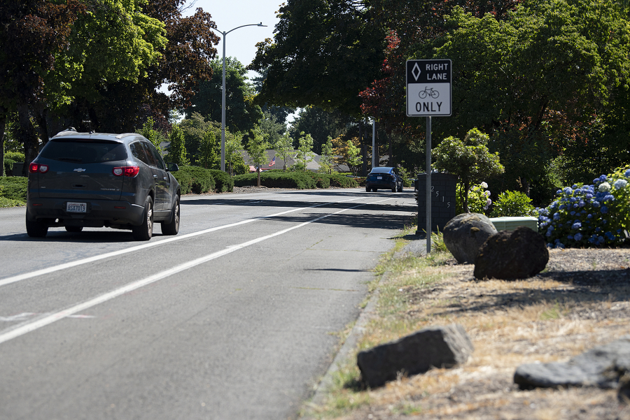 A motorist passes a stretch of Southeast McGillivray Boulevard without sidewalks in August.