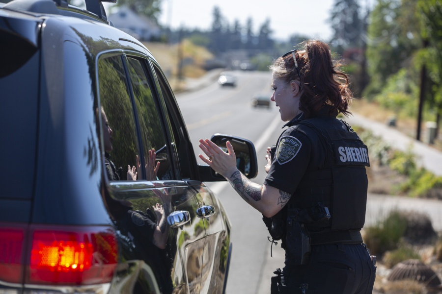 Detective Bethany Lau of the Clark County Sheriff's Office talks to a driver she pulled over for speeding in Salmon Creek. The driver was going 46 mph in a 35 mph zone and was let off with a verbal warning.