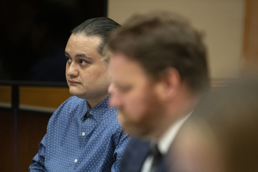 Defendant Abran Raya Leon, left, sits with his legal team Aug. 8 before opening statements in his trial in Clark County Superior Court.