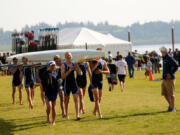 Rowers carry their boats during the U.S. Rowing Junior District Championships at Vancouver Lake.