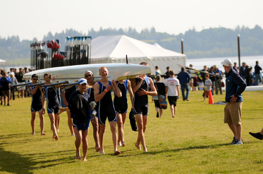 Rowers carry their boats during the U.S. Rowing Junior District Championships at Vancouver Lake.