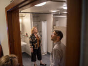 Vancouver Mayor Anne McEnerny-Ogle, center, and LSW architect Jacob DeNeui examine the redesigned bathroom at the men's shelter at St. Paul Lutheran Church.