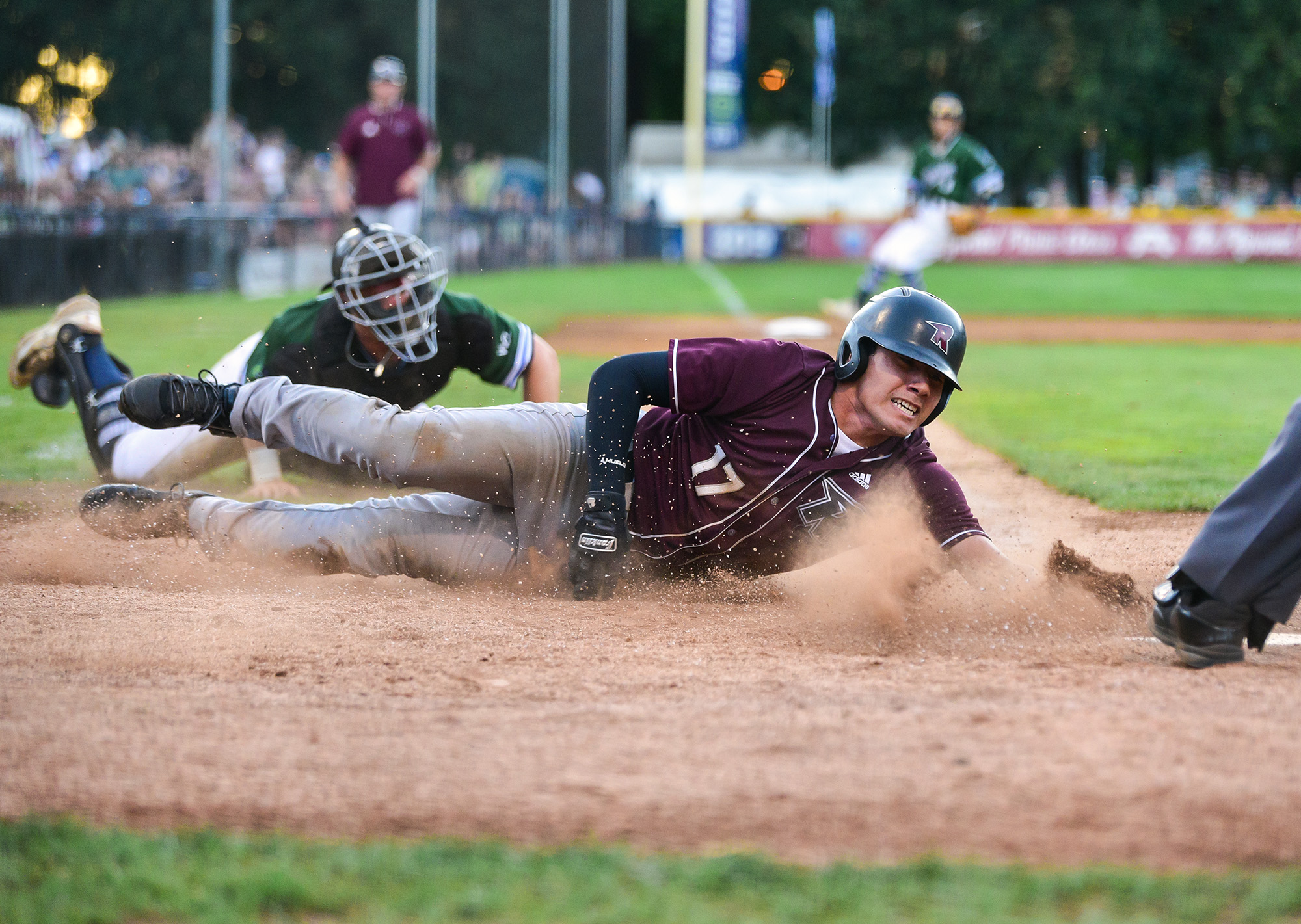 Raptors designated hitter Ryan Camacho, right, slides into home plate Tuesday, Aug. 8, 2023, during the Raptors’ 10-6 loss to the Pickles in the first game of the WCL Divisional Series at Walker Stadium in Portland.
