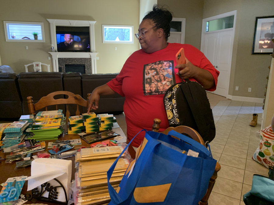 Lequoya Elliott prepares to hand out hundreds of backpacks full of school supplies. She also makes monthly visits to homeless camps and gives out hygiene kits, sleeping bags, blankets, flashlights and whatever else she can afford to buy with the money she's raised.