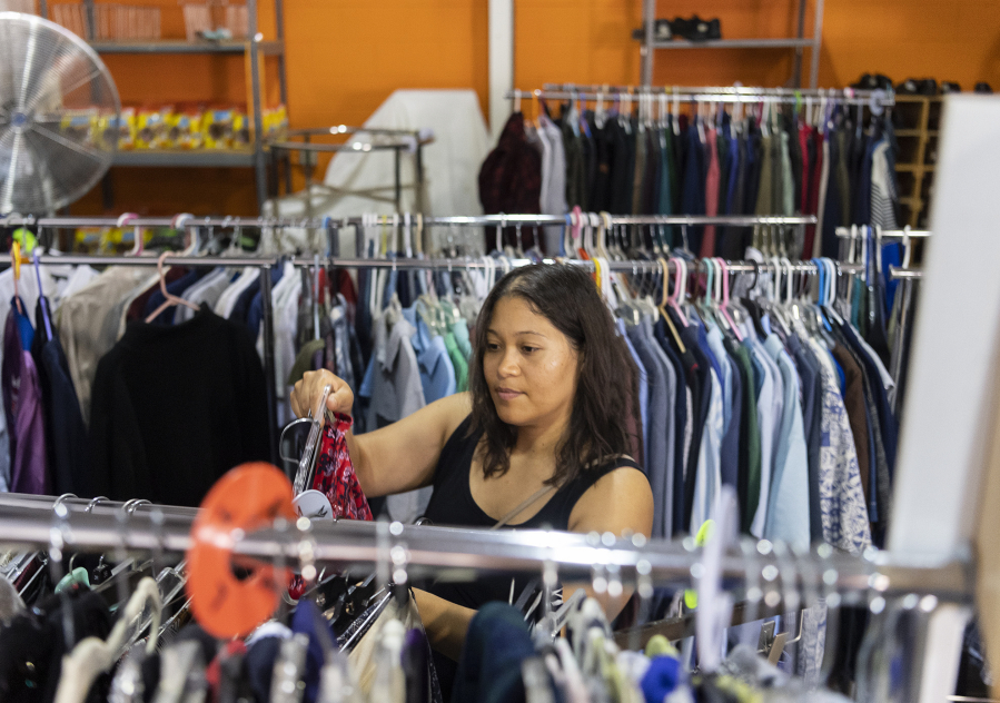 Leticia Amezcua looks for clothes Wednesday at The Giving Closet. Amezcua said she's been shopping for her family here for 15 years. Founder Denise Currie says the free community store could be forced to close in as little as five months if it does not find new funding sources.