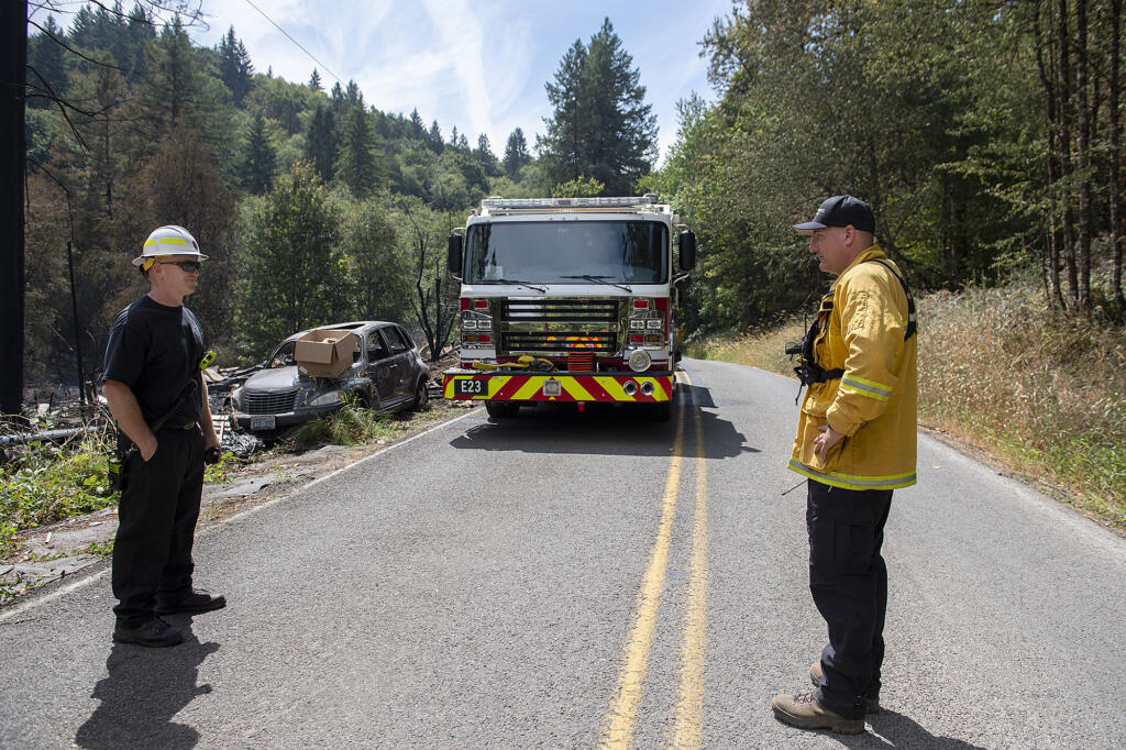 Battalion Chief Jason Leavitt, left, and Division Chief Ben Peeler take a moment to check in at the Jenny Creek Fire near La Center on Thursday afternoon, Aug. 17, 2023.