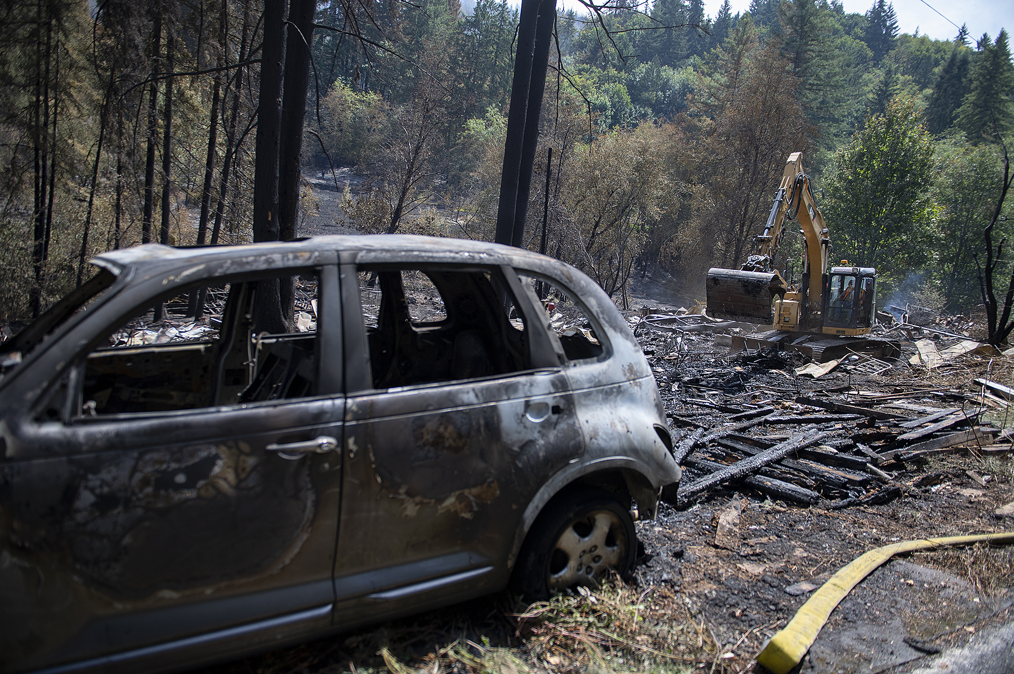 Cleanup begins on the Jenny Creek Fire site near La Center on Thursday afternoon, Aug. 17, 2023. The fire started at a residence and spread to wooded areas.