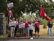 School administrators join Washington State University alumni and supporters as they greet students and staff on the first day of classes at Washington State University Vancouver on Monday morning.