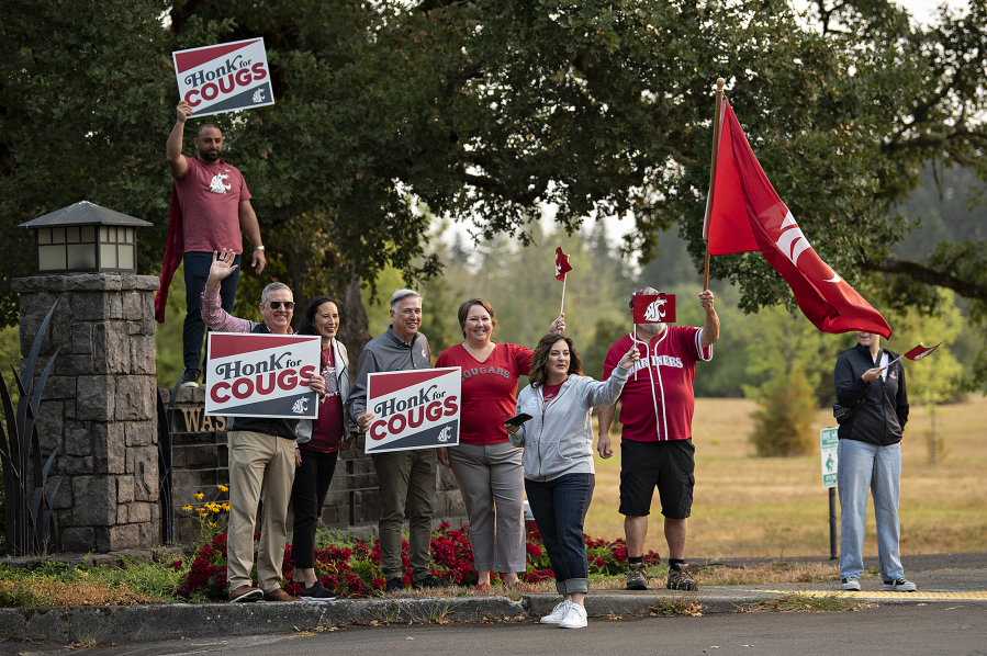 School administrators join Washington State University alumni and supporters as they greet students and staff on the first day of classes at Washington State University Vancouver on Monday morning.