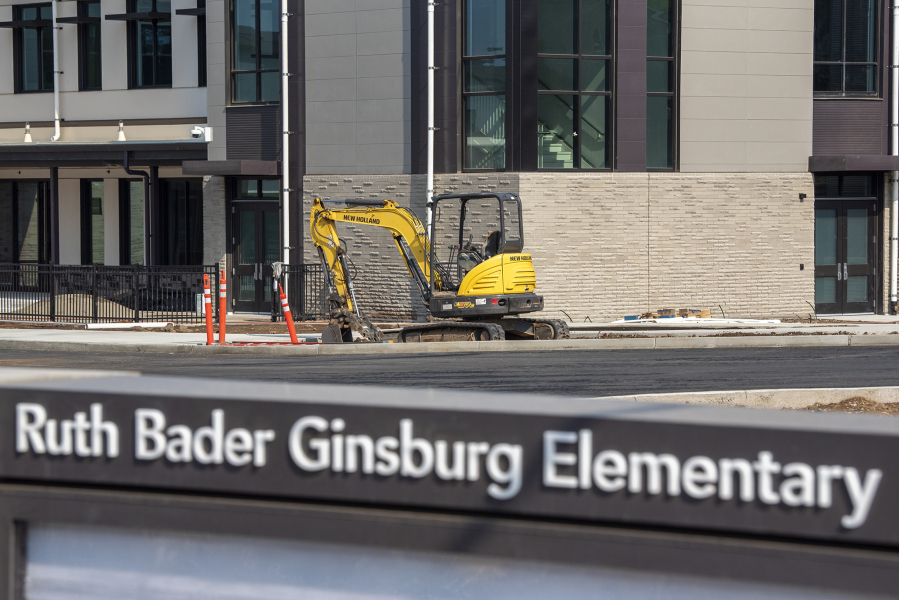 A small excavator sits in front of Ruth Bader Ginsburg Elementary School -- Vancouver Public Schools' newest elementary school -- while construction continues Friday in Vancouver.