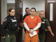 Abran Raya Leon, center, the getaway driver in the fatal shooting of Clark County sheriff's Sgt. Jeremy Brown, is escorted out of the courtroom following his sentencing Thursday at the Clark County Courthouse. A judge sentenced him to 27 years and one month in prison, the high end of his sentencing range.