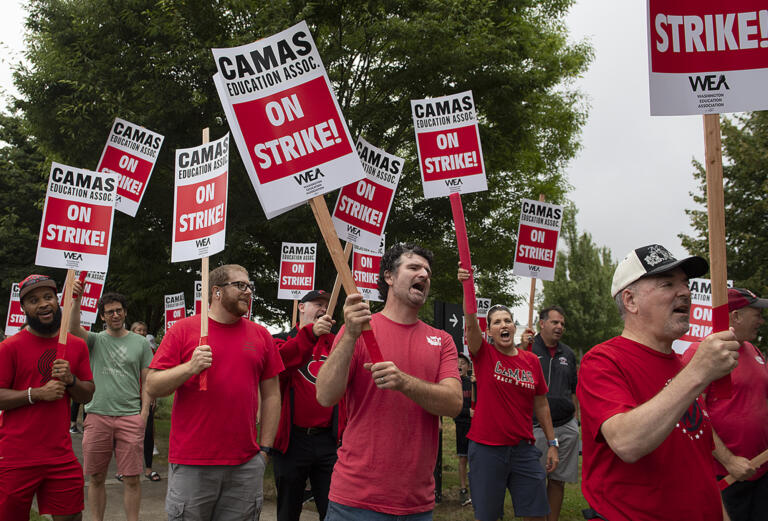 Camas teachers and supporters chant and hold their signs high as they join a district wide strike outside Camas High School on Monday morning, Aug. 28, 2023. The strike postponed the first day of school in the district.