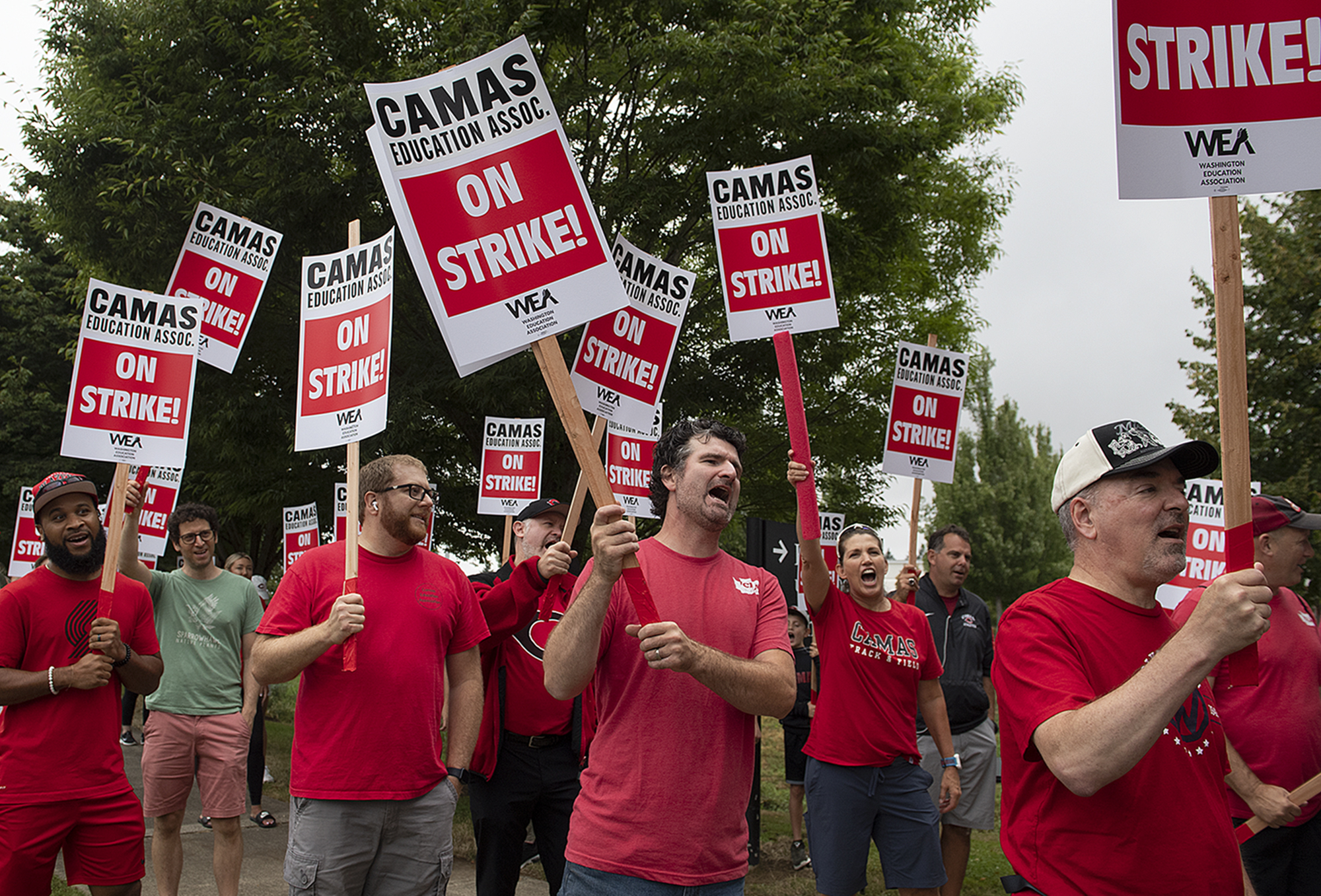 Camas teachers and supporters chant and hold their signs high as they join a district wide strike outside Camas High School on Monday morning, Aug. 28, 2023. The strike postponed the first day of school in the district.