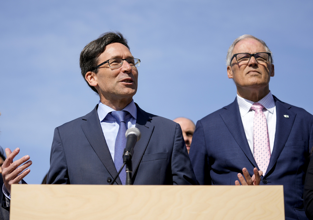 Washington Attorney General Bob Ferguson speaks as Washington Gov. Jay Inslee, right, looks on before the signing of several bills aimed at protecting reproductive health and gender-affirming care on April 27, 2023, at the University of Washington's Hans Rosling Center for Population Health in Seattle. Attorney General Ferguson launched an exploratory campaign for governor on Tuesday, May 2, 2023, one day after incumbent Jay Inslee announced he would not run again.