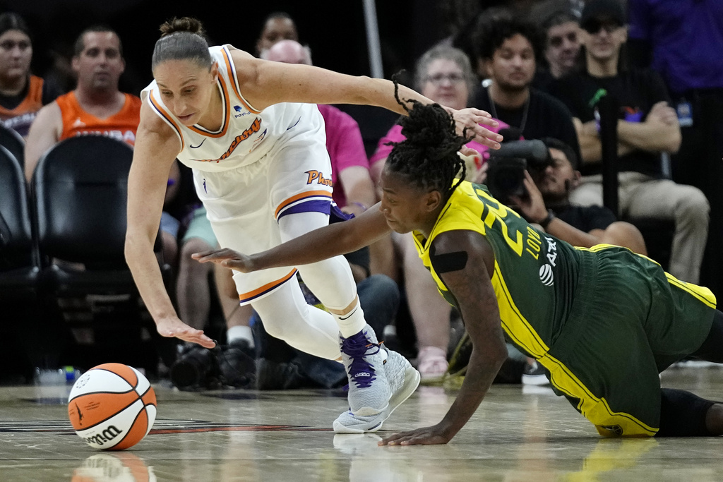 Phoenix Mercury guard Diana Taurasi, left, and Seattle Storm guard Jewell Loyd scramble for the ball during the second half of a WNBA basketball game Saturday, Aug. 5, 2023, in Phoenix. The Storm won 97-91. (AP Photo/Ross D.