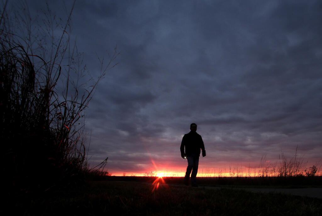 FILE - In this Nov. 20, 2015 file photo, a man walks along a trail during sunset near Manhattan, Kan. In 2022, about 49,500 people took their own lives in the U.S., the highest number ever, according to data from the Centers for Disease Control and Prevention released on Thursday, Aug. 10, 2023.