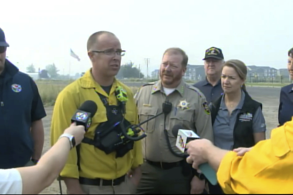 Spokane County Fire District 3 Chief Cody Rohrbach gives an update on the wildfires on Saturday, Aug. 19, 2023 in Medical Lake, Wash. The blaze started on the west side of Medical Lake, a town west of Spokane, Friday.  The fire grew to 14.8 square miles by Saturday morning, with zero containment.