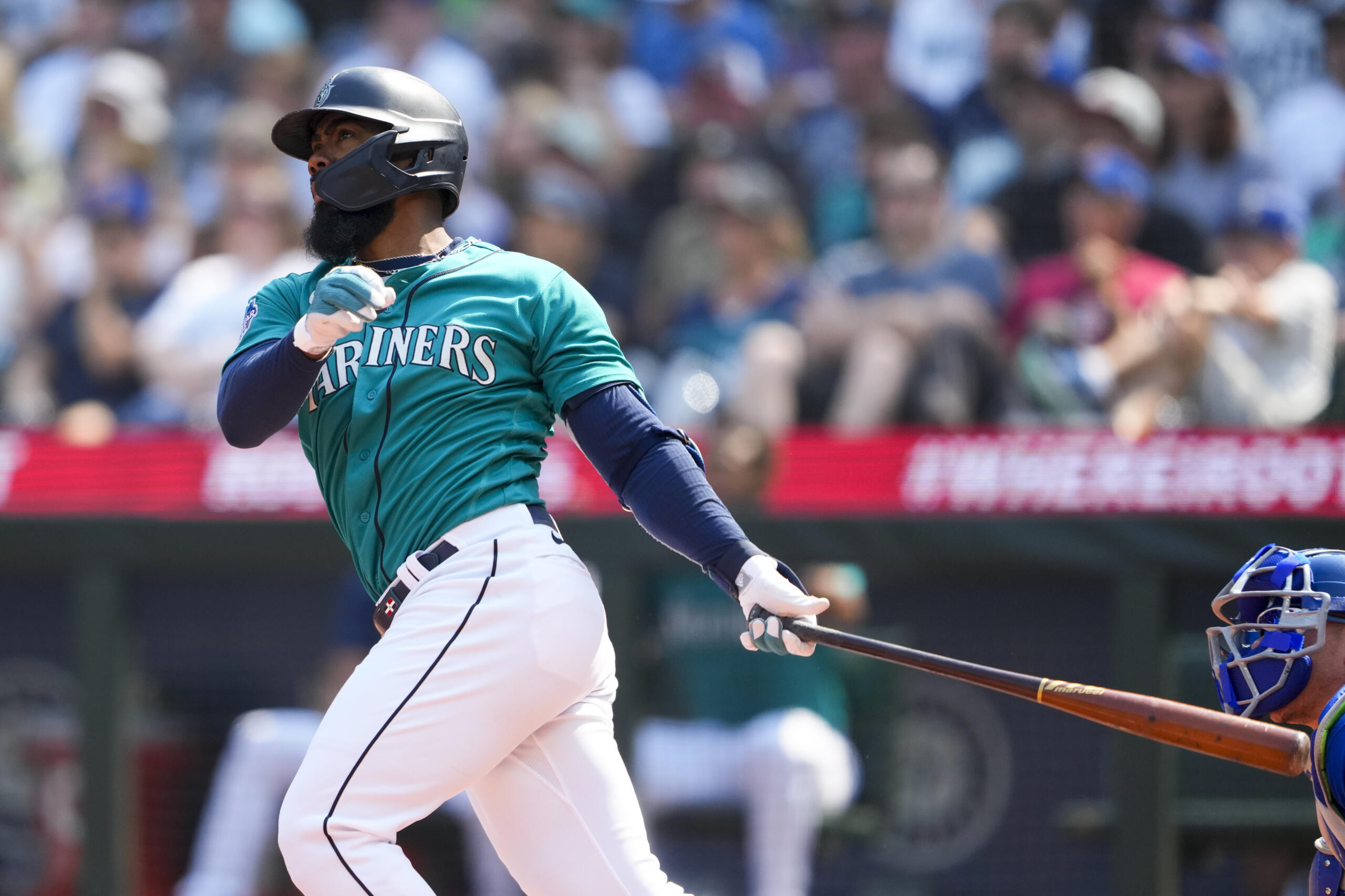 Seattle Mariners' Teoscar Hernandez follows through on a grand slam against the Kansas City Royals during the third inning of a baseball game Saturday, Aug. 26, 2023, in Seattle.