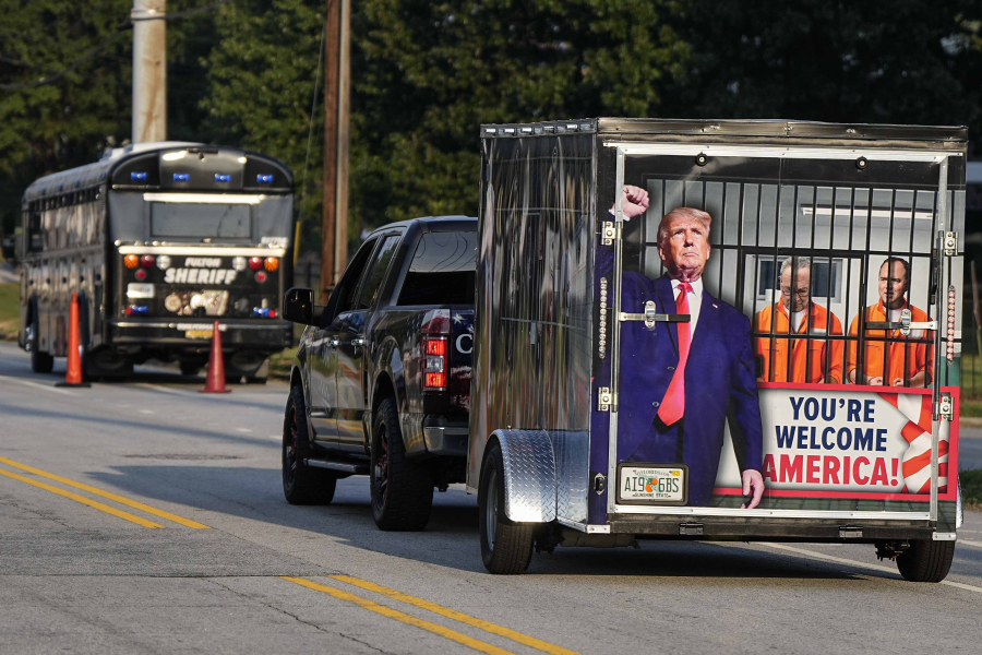 A vehicle and trailer drive by the Fulton County Jail, Thursday, Aug. 24, 2023, in Atlanta. Trump is charged alongside others, who are accused by Fulton County District Attorney Fani Willis of scheming to subvert the will of Georgia voters to keep the Republican president in the White House after he lost to Democrat Joe Biden.