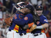 Houston Astros starting pitcher Framber Valdez, center, is embraced by catcher Martin Maldonado and third baseman Alex Bregman after throwing a no-hitter against the Cleveland Guardians, Tuesday, Aug. 1, 2023, in Houston. (AP Photo/Kevin M.