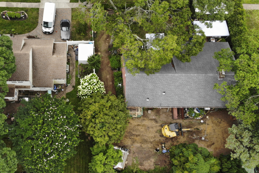 Authorities continue to work at the home of suspect Rex Heuermann, bottom right, in Massapequa Park, N.Y., Monday, July 24, 2023. Heuermann has been charged with killing at least three women in the long-unsolved slayings known as the Gilgo Beach killings.