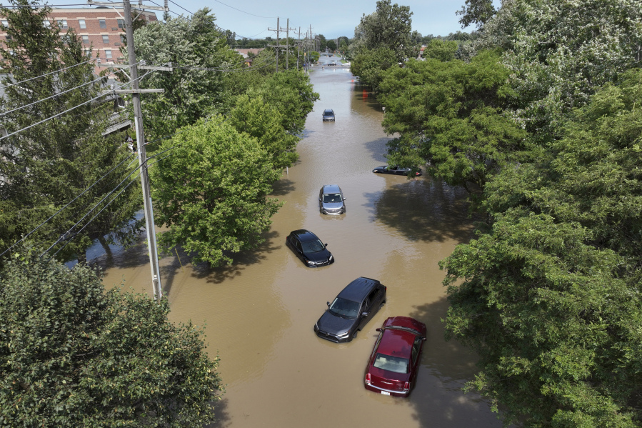 Cars are stranded in floodwaters on Sheldon Road south of Ford road in Canton, Mich., on Thursday. Officials say parts of southeast Michigan got more than 5 inches of rain by Thursday morning resulting in street flooding in the Detroit area.