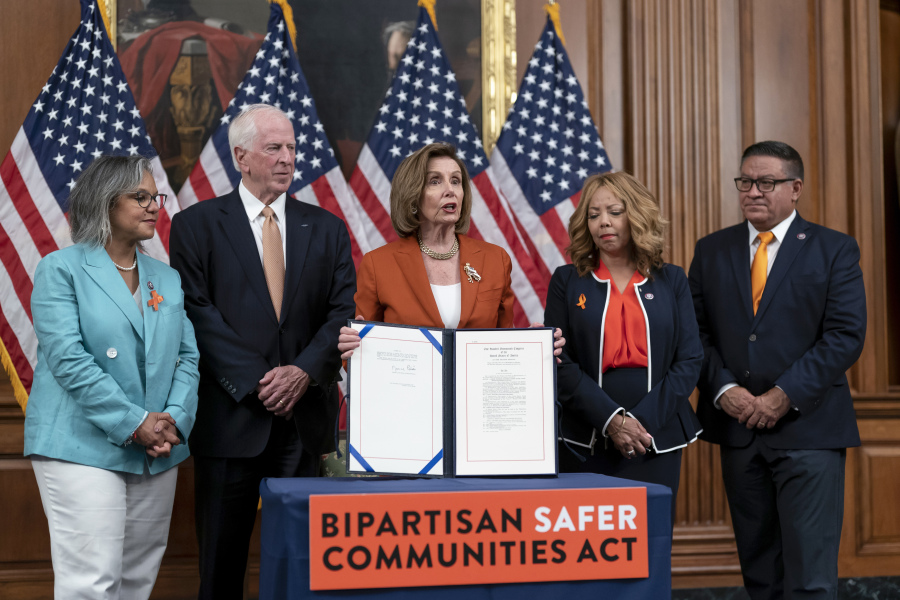 FILE - Speaker of the House Nancy Pelosi, D-Calif., center, is joined by, from left, Rep. Robin Kelly, D-Ill., Rep. Mike Thompson, D-Calif., chairman of the House Gun Violence Prevention Task Force, Rep. Lucy McBath, D-Ga., and Rep. Salud Carbajal, D-Calif., as she enrolls the gun violence safety bill before sending it to President Joe Biden to sign it into law, at the Capitol in Washington, June 24, 2022. (AP Photo/J.