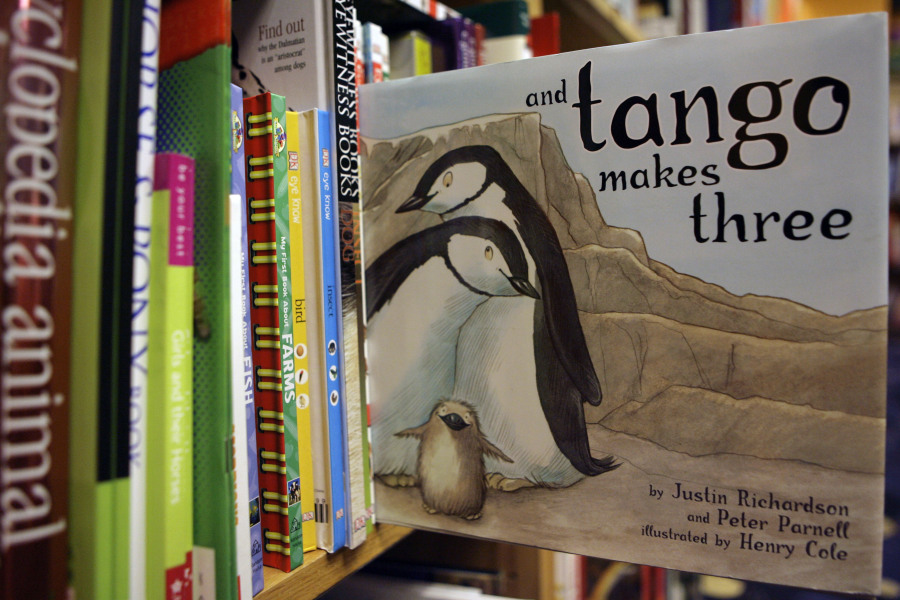 FILE - A copy of the book "And Tango Makes Three" is photographed on a bookstore shelf in Chicago, Nov. 16, 2006. Months after access to the popular children's book about a male penguin couple hatching a chick was restricted at school libraries because of Florida's so-called "Don't Say Gay" law, a central Florida school district says it has reversed that decision. The complaint challenged the restrictions and Florida's new law prohibiting classroom discussion about sexual orientation or gender identity in certain grade levels.  (AP Photo/Nam Y.