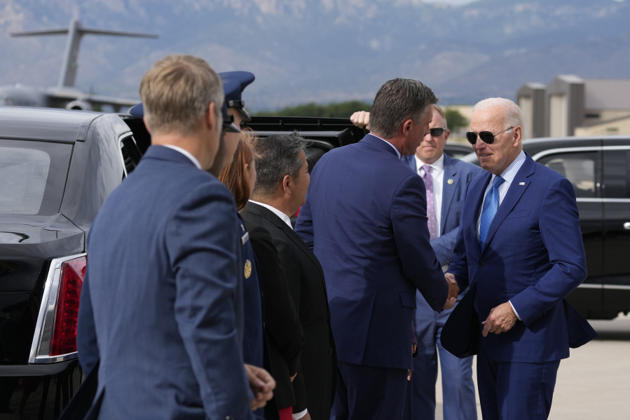 President Joe Biden greets people upon arrival at Kirtland Air Force Base, Tuesday, Aug. 8, 2023, in Albuquerque, N.M.