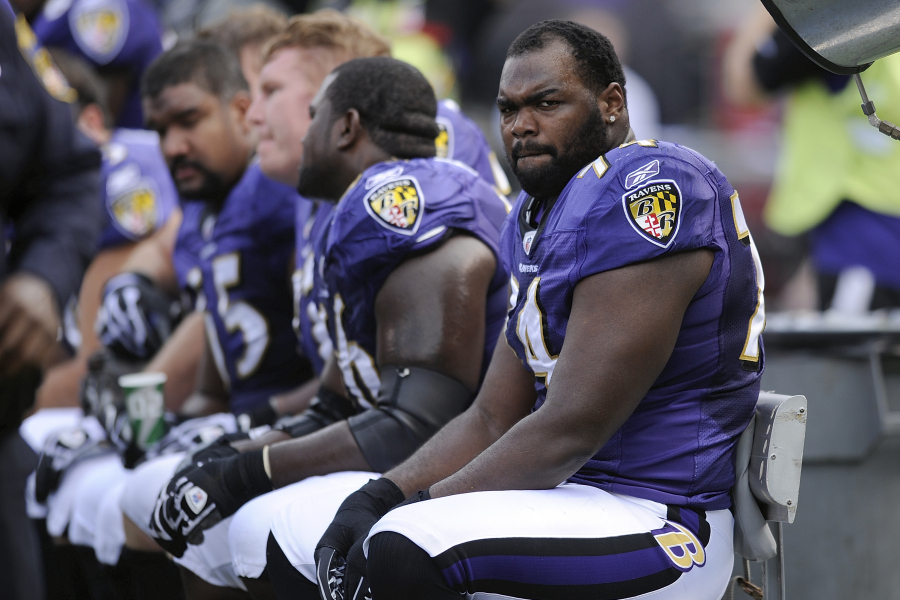 FILE - Baltimore Ravens offensive tackle Michael Oher sits on the beach during the first half of an NFL football game against the Buffalo Bills in Baltimore, Sunday, Oct. 24, 2010.