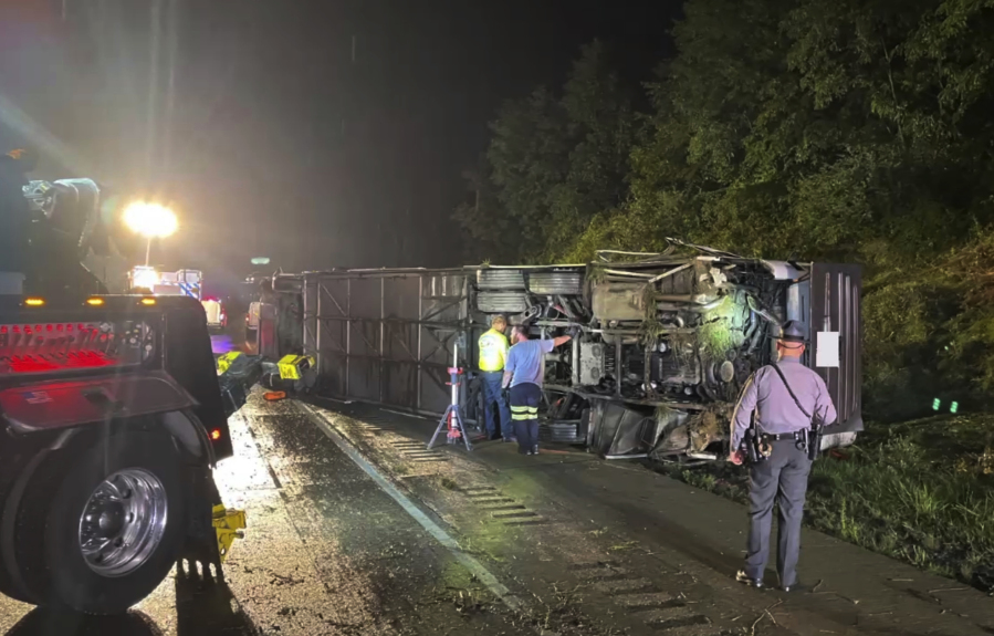 Police and rescue workers arrive on the scene of a bus crash late Sunday, Aug. 6, 2023, in Lower Paxton Township, Dauphin County ,Pa. The crash occurred between a passenger vehicle and charter bus carrying up to 50 passengers causing multiple fatalities and injuries.