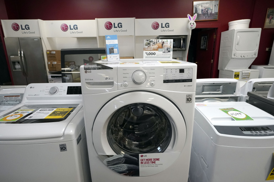 Washing machines are displayed in 2021 at Sam's Appliances TV & Furniture in Norwood, Mass. The decision replace or repair a broken appliance isn't always simple.