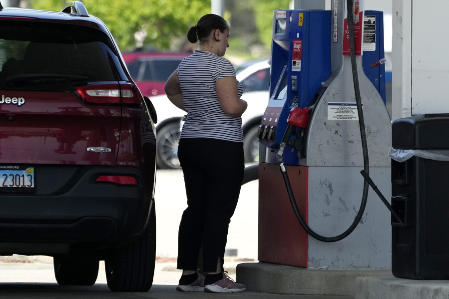 File - A customer prepares to pump gas at a filling station in Buffalo Grove, Ill., on May 10, 2023. On Thursday, the Commerce Department issues its July report on consumer spending. (AP Photo/Nam Y.