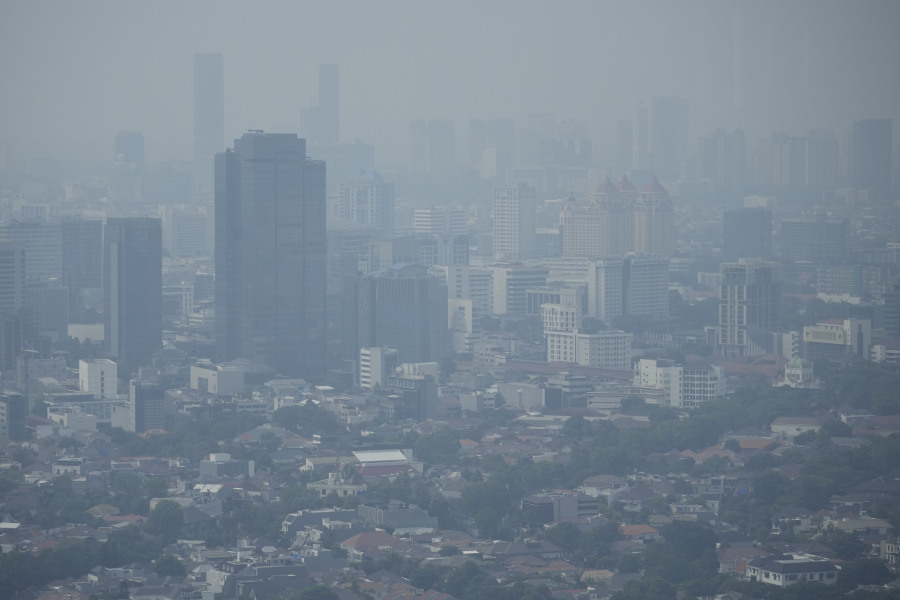 Haze blankets the main business district in Jakarta, Indonesia, on Aug. 11. According to a study, the world's corporations produce so much climate change pollution that it could eat up about 44 percent of their profits if they had to pay damages for what they spew.