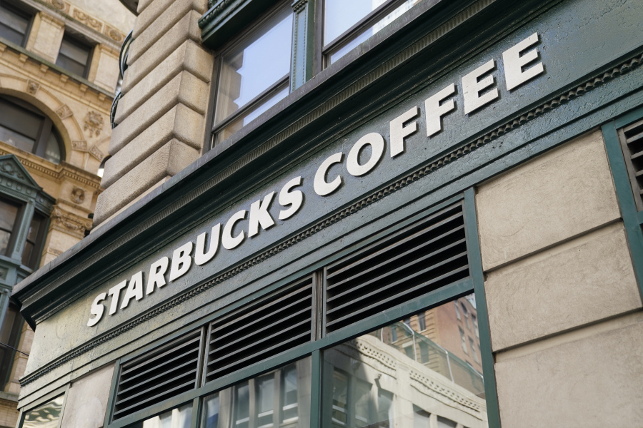 FILE - A Starbucks sign is displayed above a store in the Financial District of Lower Manhattan, Tuesday, June 13, 2023, in New York. Starbucks reports earnings on Tuesday, Aug. 1.