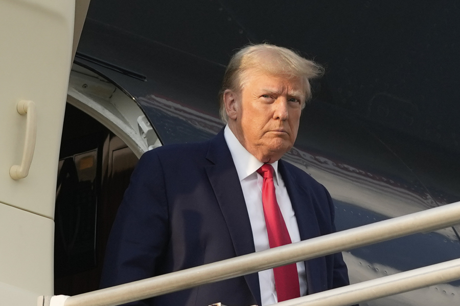 FILE - Former President Donald Trump steps off his plane as he arrives at Hartsfield-Jackson Atlanta International Airport, Thursday, Aug. 24, 2023, in Atlanta.