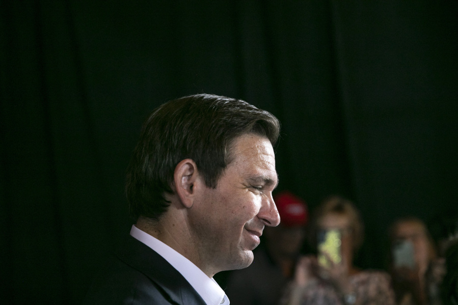 Republican presidential candidate Florida Gov. Ron DeSantis prepares to pose for a photo with supporters, Thursday, Aug. 10, 2023, at Iowa River Power Restaurant in Iowa City, Iowa.