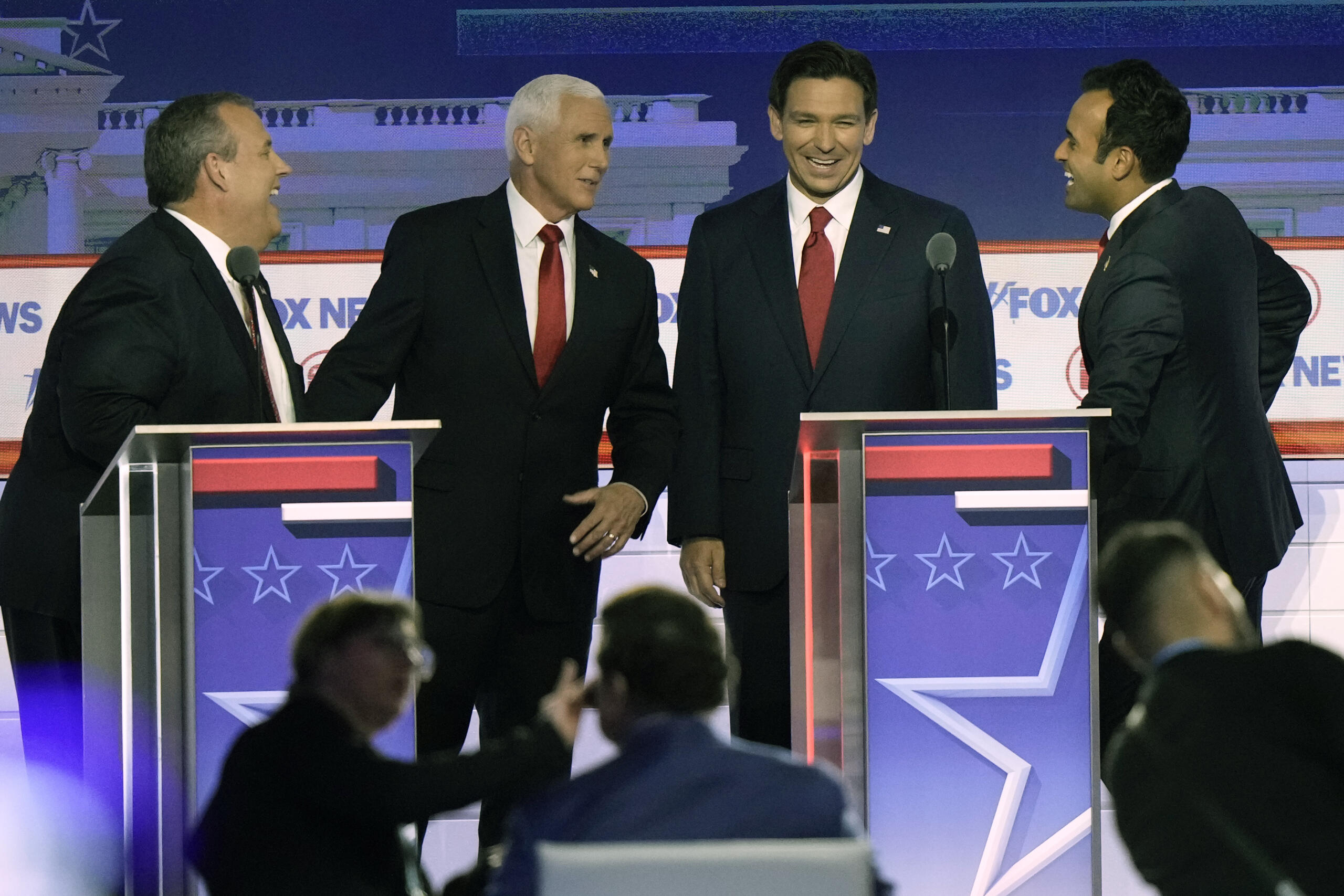 Former New Jersey Gov. Chris Christie, former Vice President Mike Pence, Florida Gov. Ron DeSantis and businessman Vivek Ramaswamy talk during break in a Republican presidential primary debate hosted by FOX News Channel Wednesday, Aug. 23, 2023, in Milwaukee.